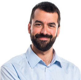 man with dark hair and facial hair wearing a blue shirt